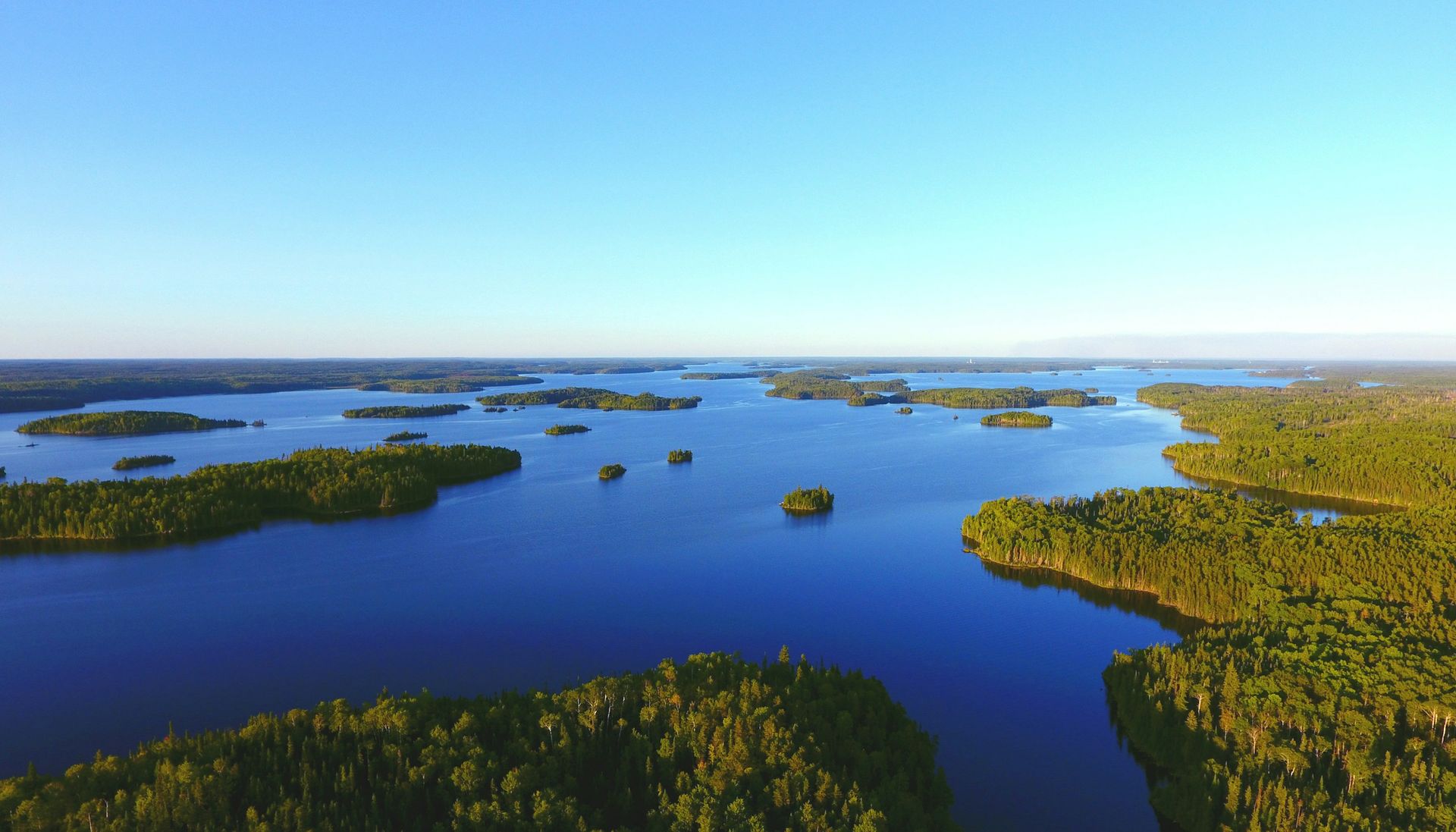 Aerial view of forested islands in a blue lake